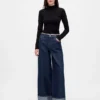 Baggy-jeans med middels høy midje og metalliske mansjetter