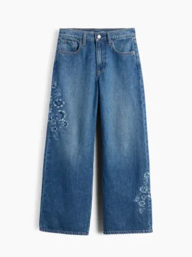 Barnjeans med lav midje, bred benvidde og brodert blomstermønster