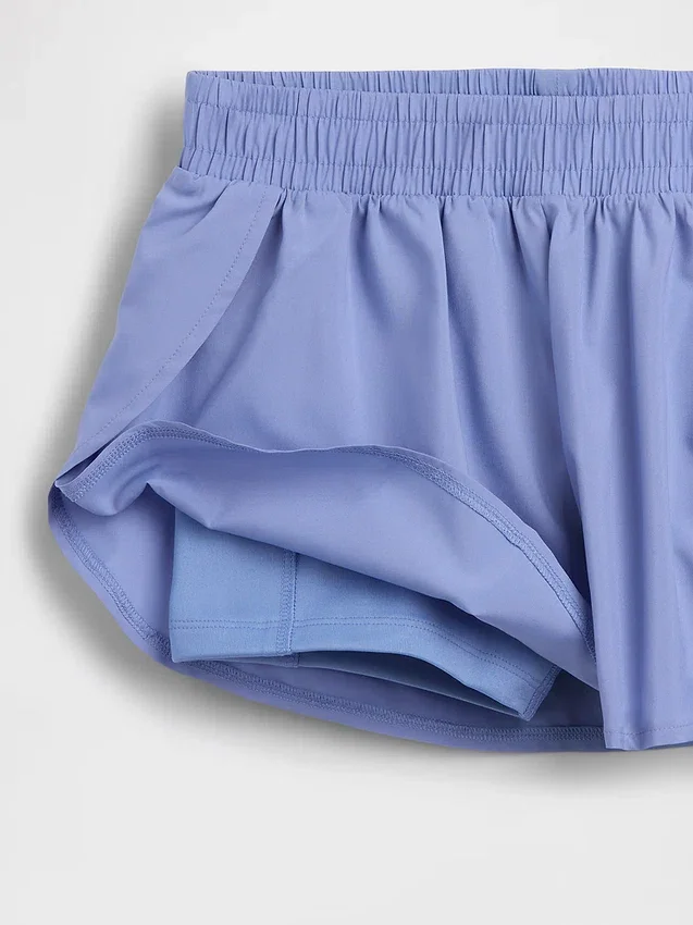 Hurtigtørkende løpeshorts med sommerfuglkant for barn