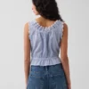 Kort peplum-top med bånd i fronten og hullkant