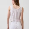 Kort peplum-top med bånd i fronten og hullkant