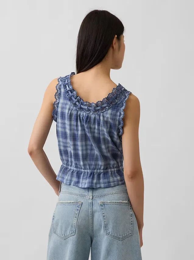 Kort peplum-top med bånd i fronten og hullkant