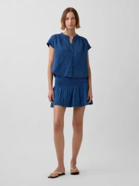Mini-skort i bomullsgasdenim med smocket midje