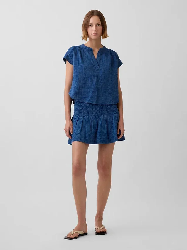 Mini-skort i bomullsgasdenim med smocket midje