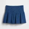 Mini-skort i bomullsgasdenim med smocket midje