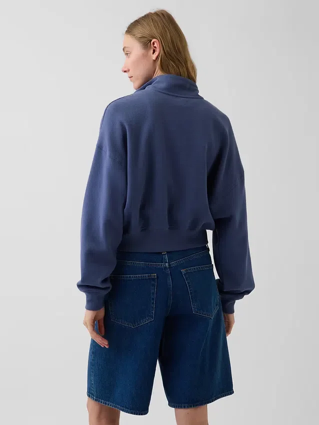 Oversized genser i strukturert bomull med halv glidelås
