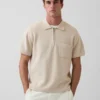 Oversized polo-genser med kvart glidelås og lomme