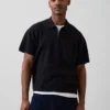 Oversized polo-genser med kvart glidelås og lomme