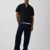 Oversized polo-genser med kvart glidelås og lomme
