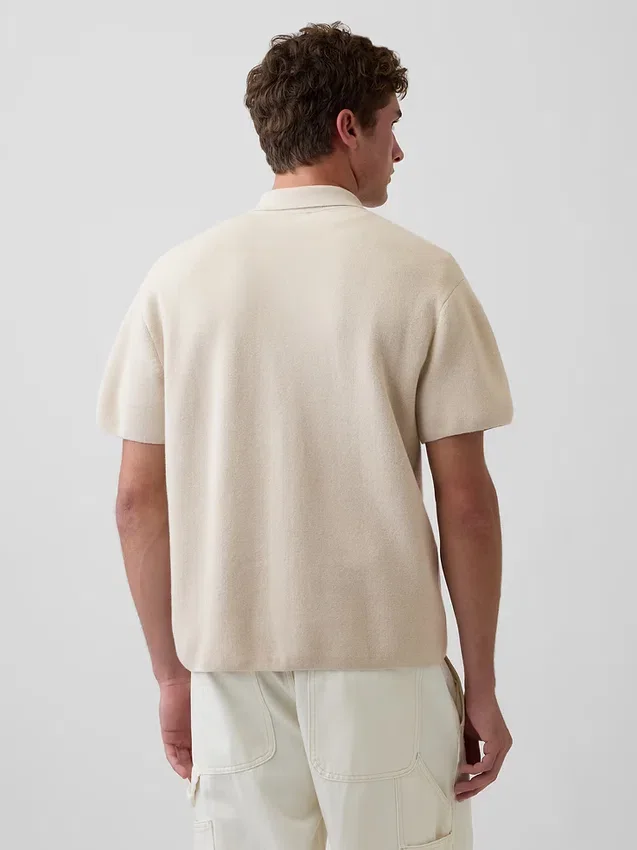 Oversized polo-genser med kvart glidelås og lomme
