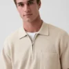 Oversized polo-genser med kvart glidelås og lomme