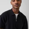 Oversized polo-genser med kvart glidelås og lomme