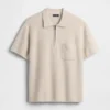 Oversized polo-genser med kvart glidelås og lomme