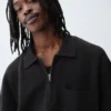 Oversized polo-genser med kvart glidelås og lomme