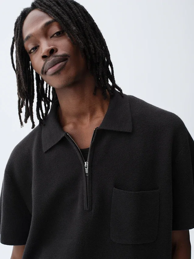Oversized polo-genser med kvart glidelås og lomme