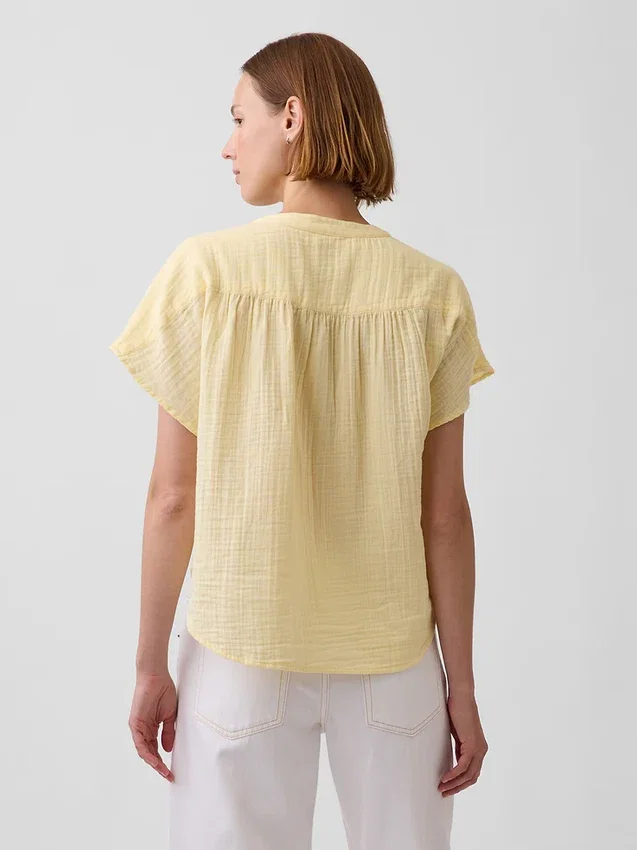 Oversized topp i bomullsgasbind med splitt i halsen