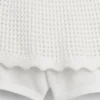 Skort med lag på lag i heklet bomull for barn