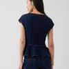 Tettsittende denim-top med kappeerm og peplum