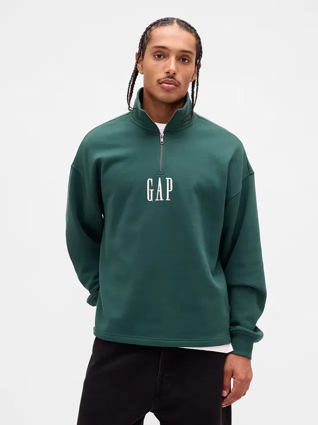 Tung, oversized genser med logo og kvart glidelås