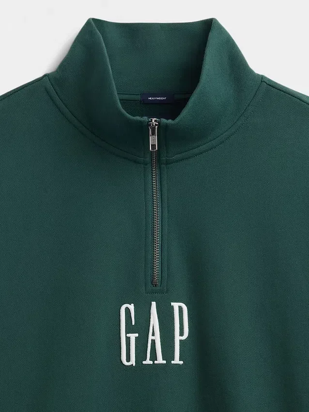 Tung, oversized genser med logo og kvart glidelås